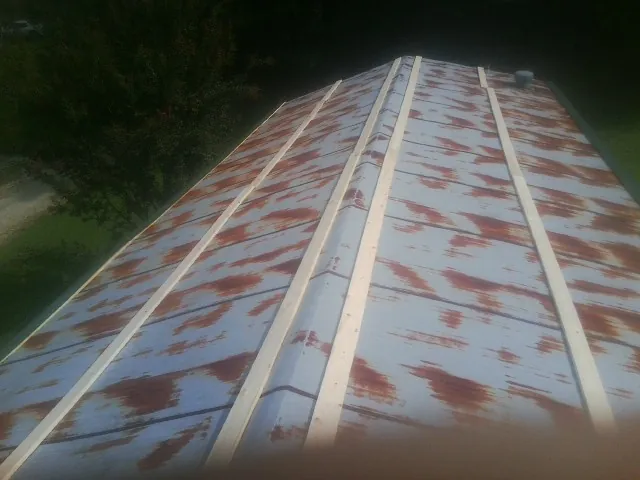Rusted metal roof panels with new wood purlins before replacement — Storm Damage Roof Repair in Kittanning by Roofing Brothers