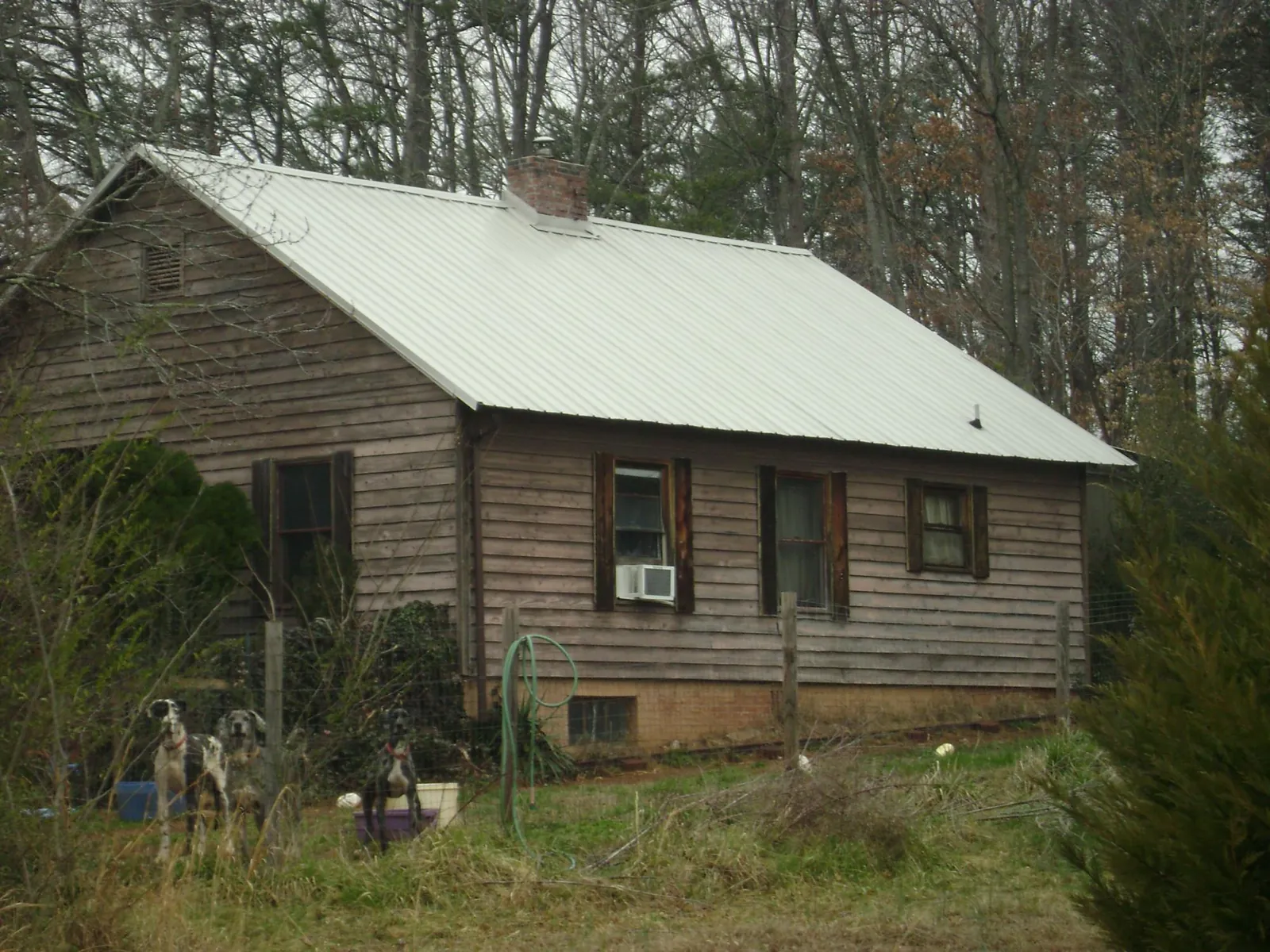 White metal roof on an old wood sided farmhouse, from a Metal Roof Installation job in Kittanning